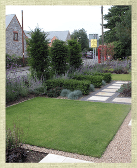 Modern front garden with turfed area and gravel and paved path